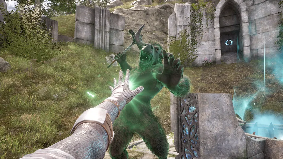A first-person spellcaster's hand glows as a green troll charges near stone ruins