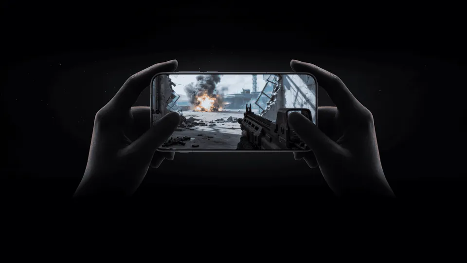 Two hands hold the OnePlus 16 sideways while it runs a first-person shooter game