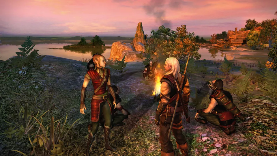 Geralt stands with a red-clad companion by a lake at sunset in the first Witcher game