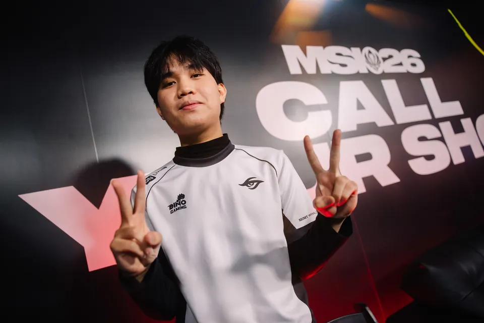 A Team Secret Whales player flashes peace signs in front of the MSI 2026 Call Your Shot wall in Daejeon