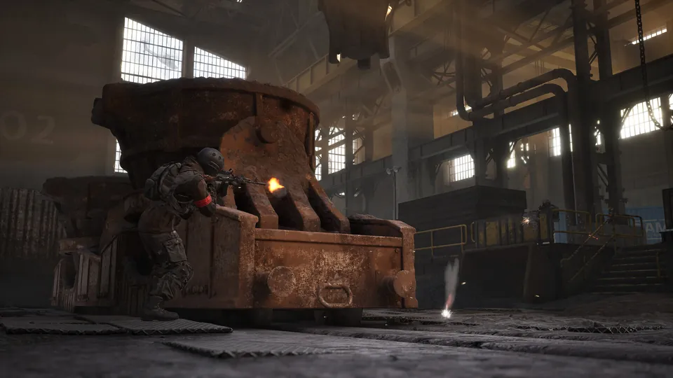 WARDOGS soldier firing from behind a rusty steel crucible inside a dark factory hall