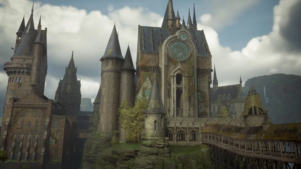 The towers and clock face of Hogwarts castle rise above a covered wooden bridge under a cloudy sky in Hogwarts Legacy on Nintendo Switch 2