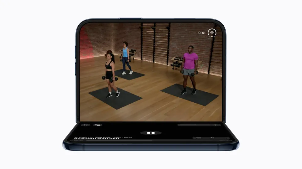 A half-folded iPhone Duo in night sky playing a workout video on the top half of its inner screen