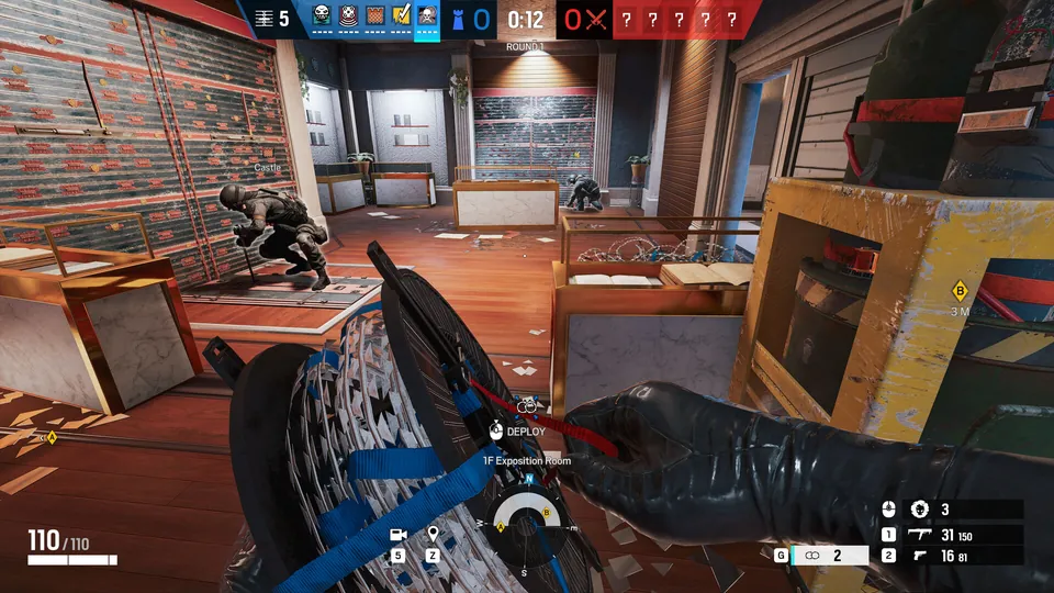An operator deploys a gadget behind a reinforced counter during a Rainbow Six Siege round