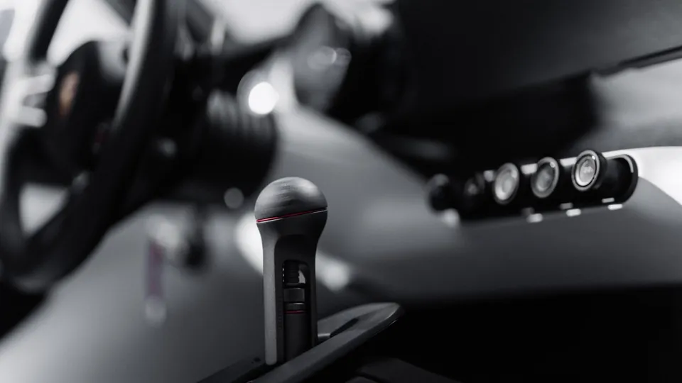 A close-up of the Porsche Mission S center tunnel and the row of round switches on the dashboard