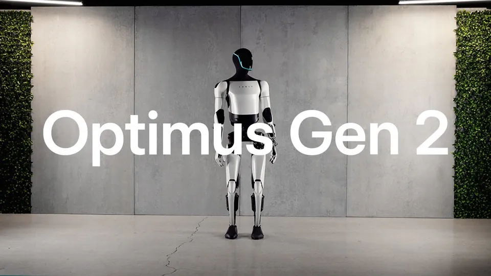 Tesla's Optimus Gen 2 humanoid robot standing in front of a concrete wall, with the words Optimus Gen 2