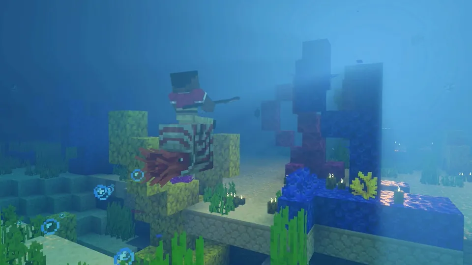 An underwater Minecraft scene with coral, kelp and a sunken ruin