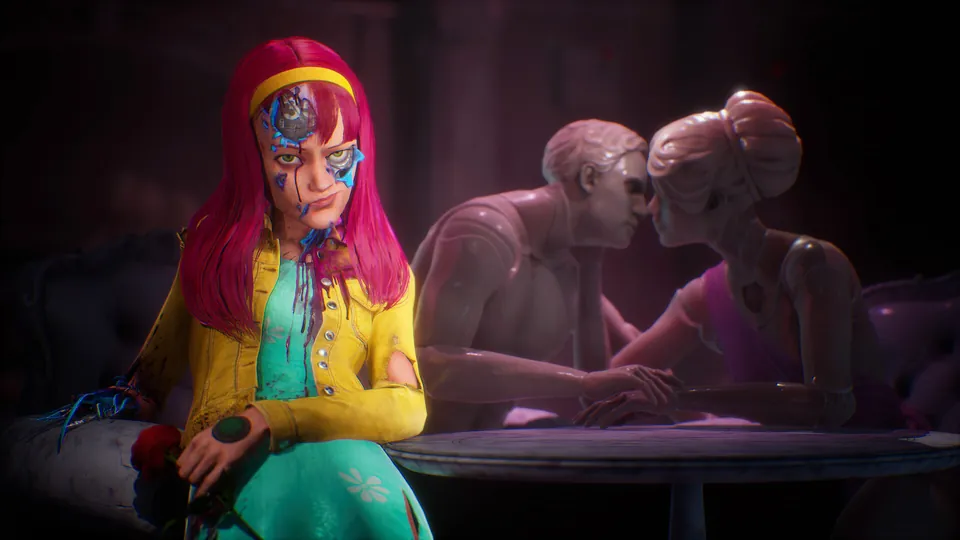 Judas, with pink hair and a cracked mechanical face, sits on a couch beside a kissing couple of statues in Judas