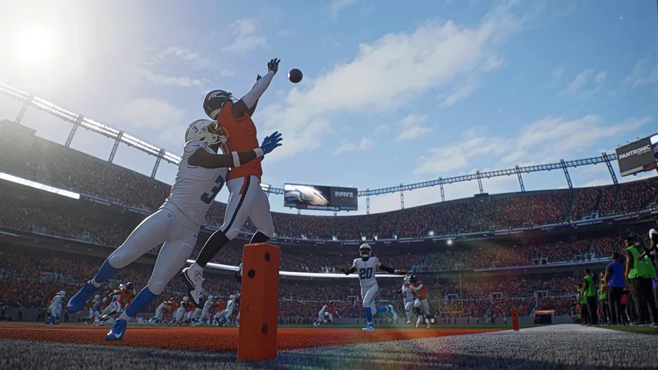 A receiver and a defender leap for a pass near the end zone in a Denver stadium in Madden NFL 27
