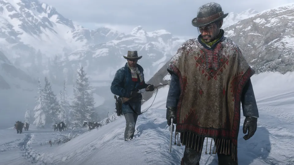 Two outlaws in hats and ponchos trudge through deep snow in the mountains in Red Dead Redemption 2