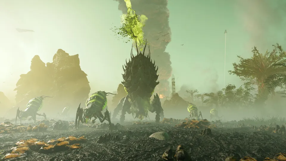 Huge spiky bugs crossing a misty alien plain under a green sky, with a plume of smoke rising behind them