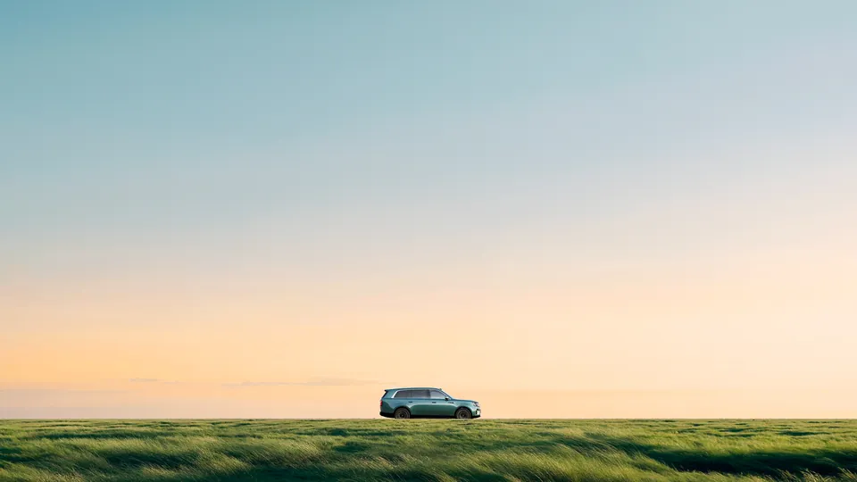 The Xiaomi Pengcheng N90 Max in profile on a green field under an evening sky