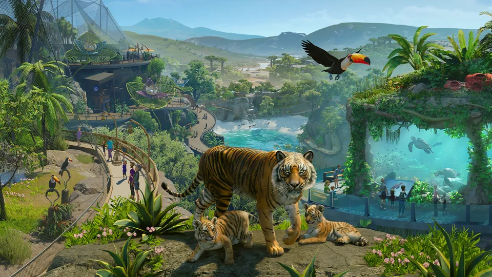 A tiger with two cubs, a toucan in flight and an aquarium wall in a jungle-themed zoo