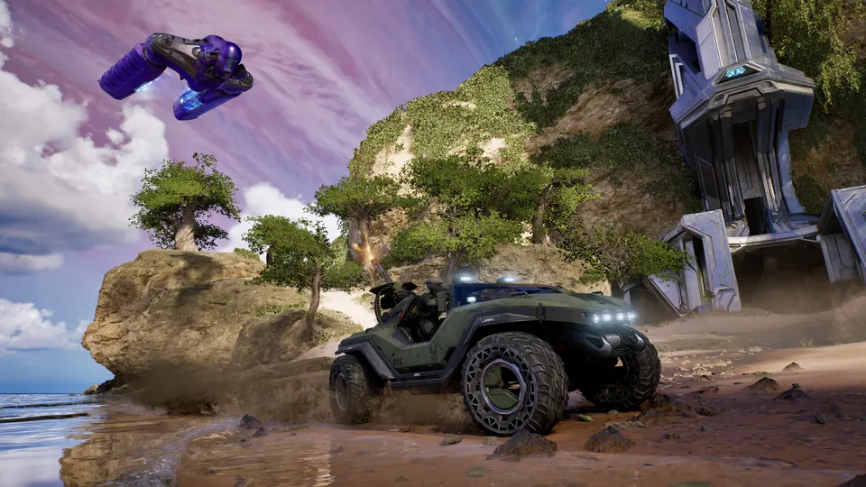 A Warthog races along a sunny beach as a purple Banshee flies overhead in Halo: Campaign Evolved