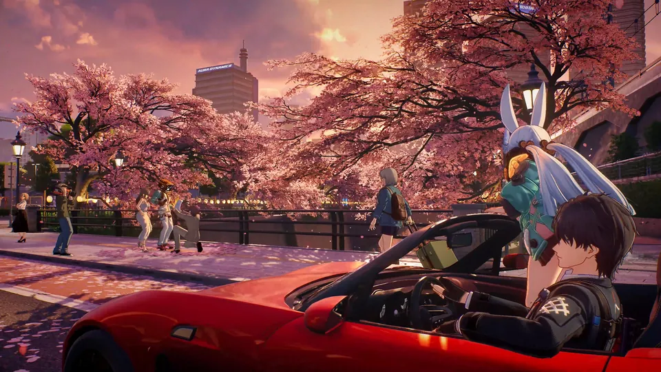 A red convertible drives under pink cherry blossoms at sunset in Ananta