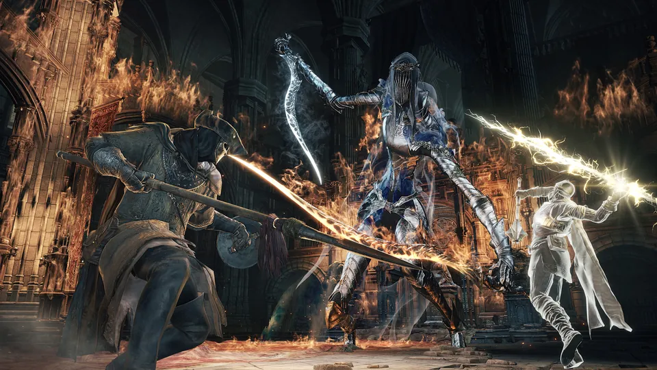 Two players with swords and a glowing blade fight a tall armored boss in a burning cathedral in Dark Souls III