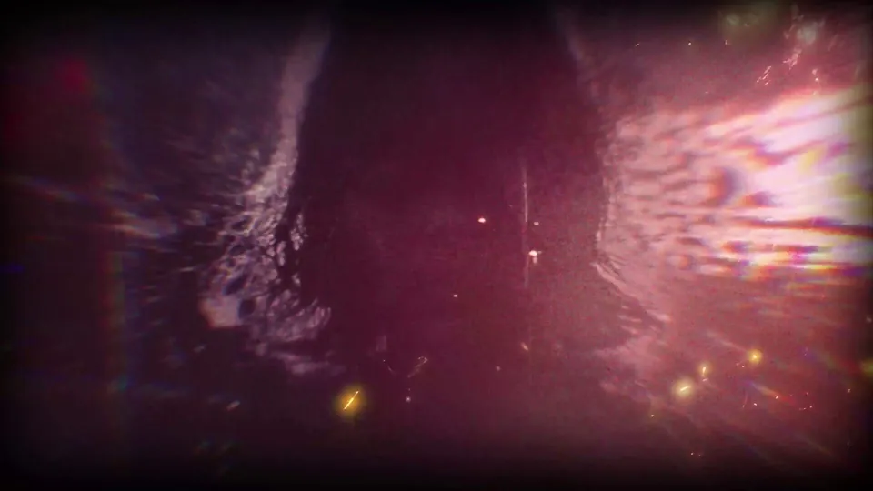 A dark figure stands in rippling water under red and violet light in the Persona 6 teaser
