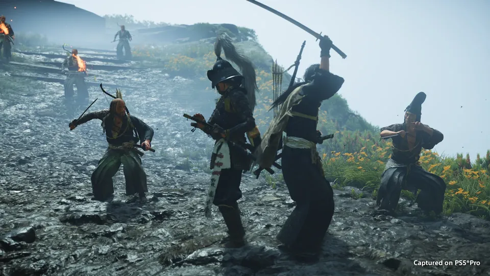 A sword fight against several armored enemies on a rocky shore in Ghost of Yōtei
