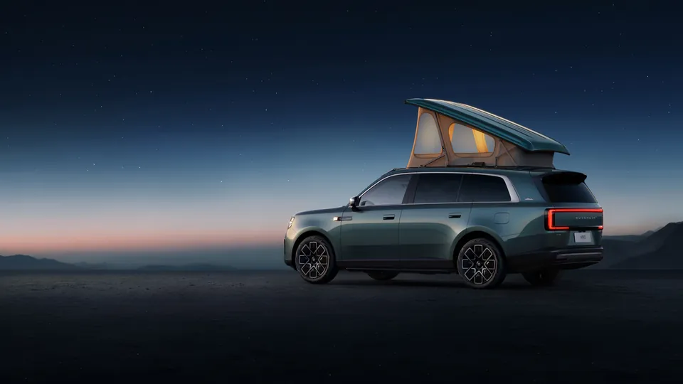 The Xiaomi Pengcheng N90 Max Explorer Edition at night with its pop-up roof raised and lit from inside