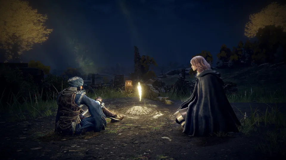 Two travelers in cloaks sit by a small golden light in a grassy field at night in Elden Ring Tarnished Edition on Nintendo Switch 2