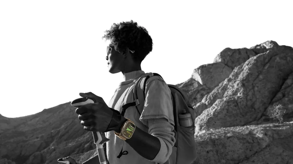 A hiker wearing Apple Watch Ultra 4 in the mountains