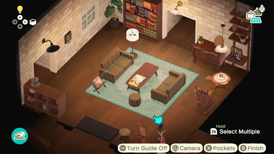 A cozy room with a sofa, bookshelves and a rug being arranged with on-screen decorating controls in Animal Crossing: New Horizons
