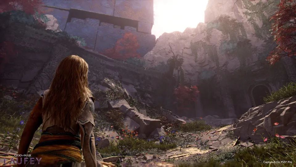 Faye walking toward ruins in a sunlit canyon
