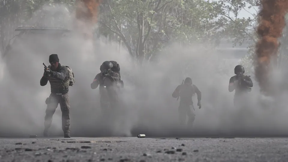 A Wardogs squad walks out of thick smoke with weapons raised