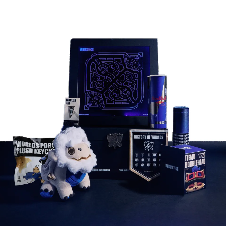 The Worlds Unlocked 2026 Collector's Edition laid out: a Teemo bobblehead box, a white plush, a tumbler, a pennant and a poro charm bag