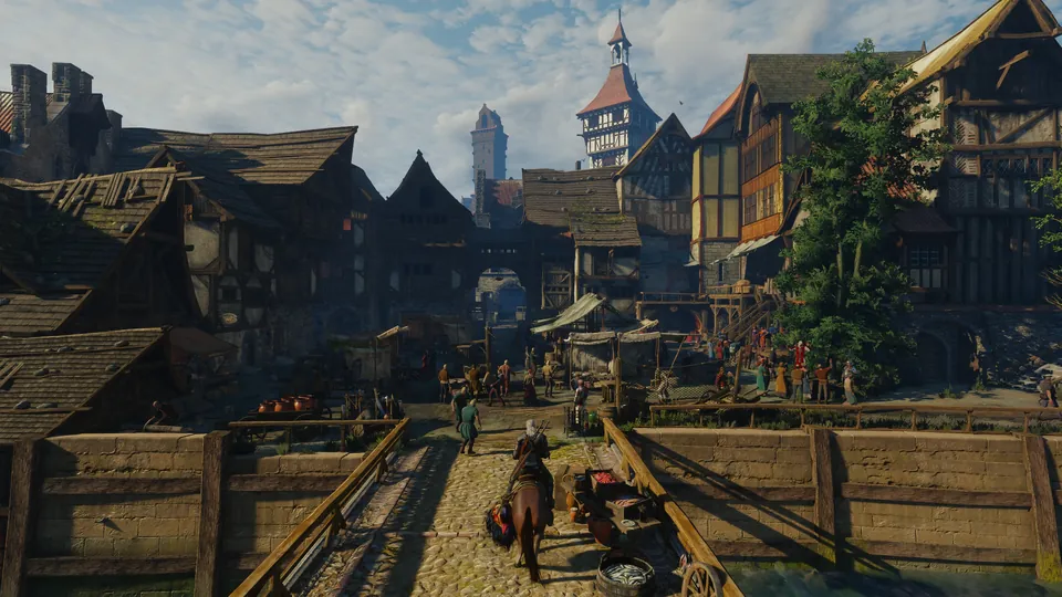 Geralt rides into a busy medieval city with timber houses and a tall church spire