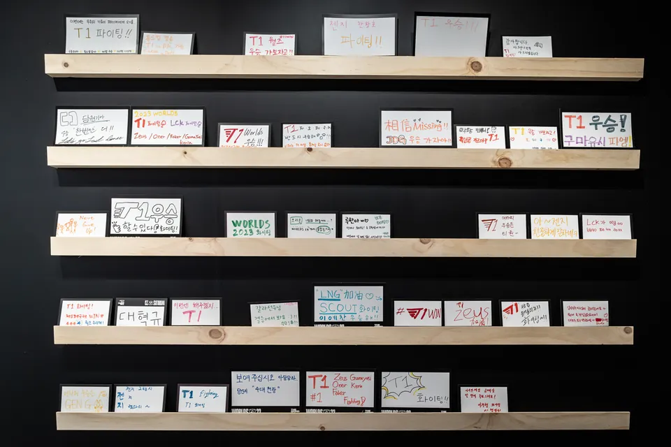 Shelves of handwritten fan signs cheering for T1 and other teams at Worlds 2023 in Korea