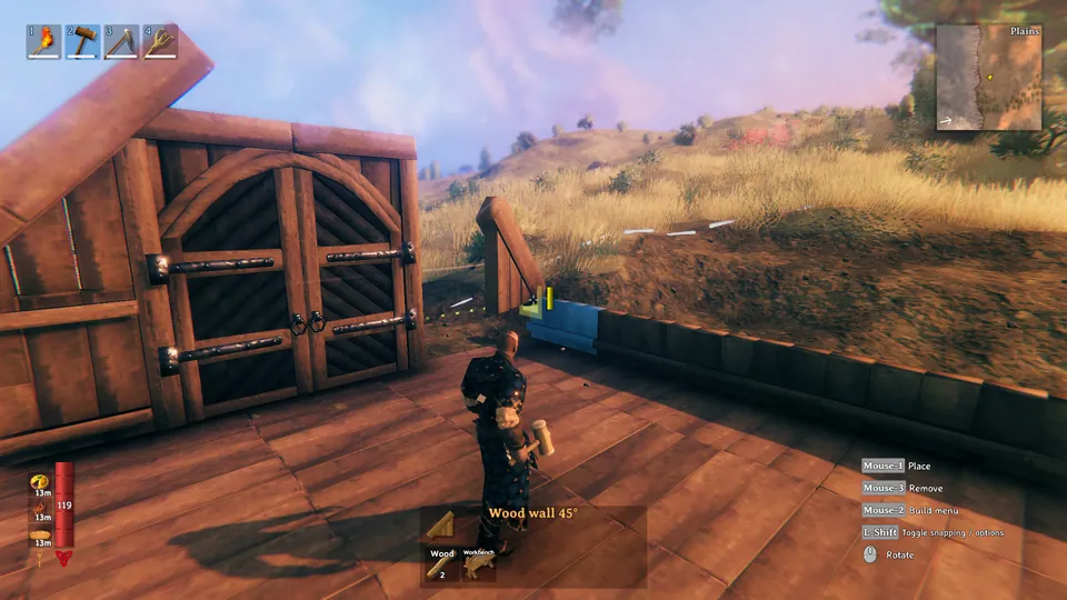 A Viking builds a wooden longhouse with a double door on a grassy hill