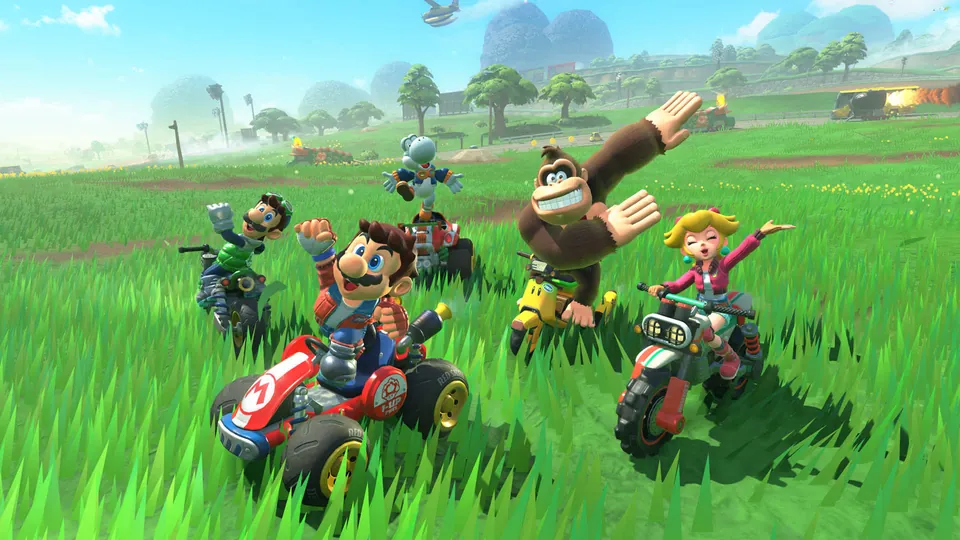 Mario, Donkey Kong, Peach and other racers cheer on a grassy field in Mario Kart World, the best-selling Switch 2 game