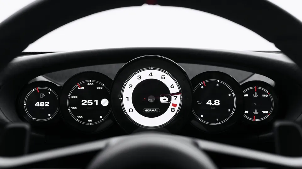 Five round digital gauges behind the Porsche Mission S steering wheel, with the tachometer in the middle