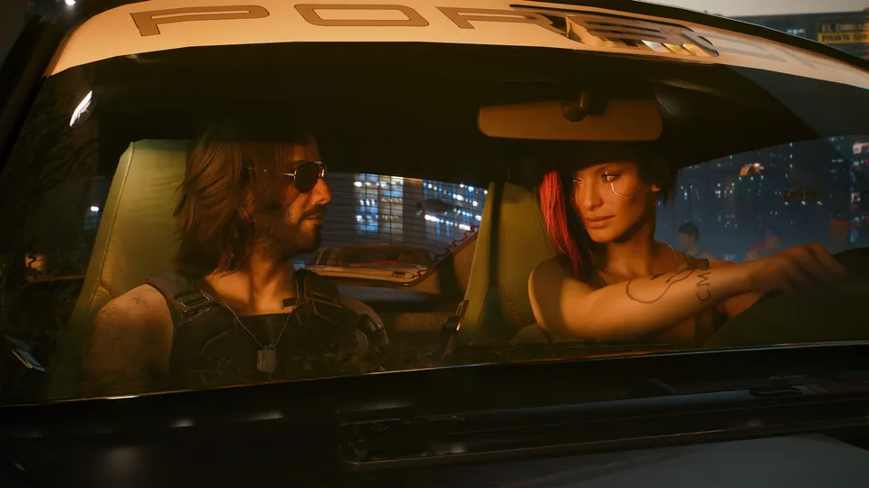 Johnny Silverhand in aviator sunglasses rides beside V, who has red hair, in a vintage sports car at night in Cyberpunk 2077