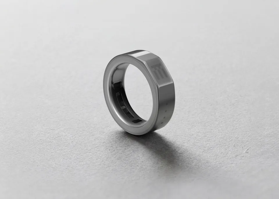 The Even R1 smart ring standing on a grey surface