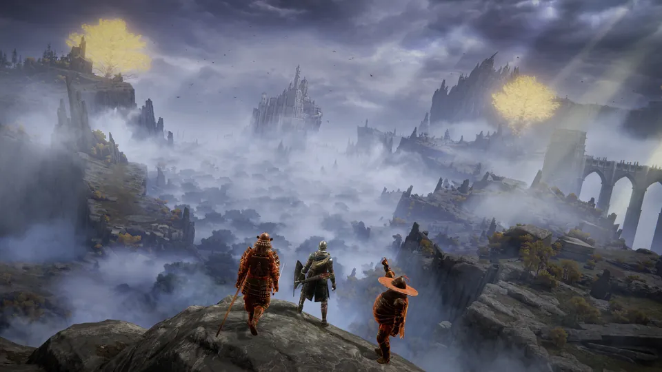 Three armored players stand on a cliff above misty ruins and a distant castle in Elden Ring