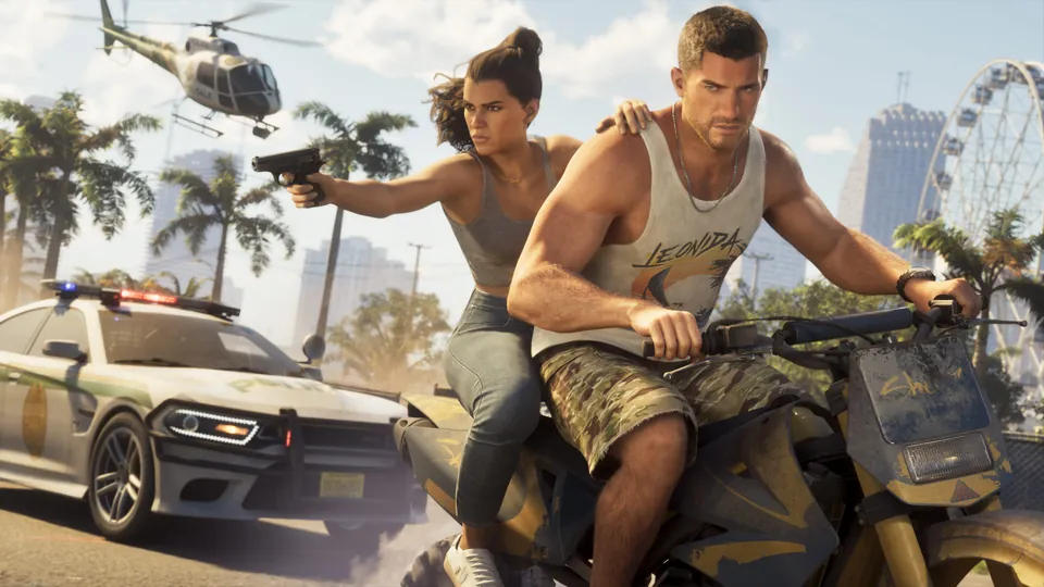 Lucia and Jason on a motorbike with guns drawn, a police car and a helicopter behind them
