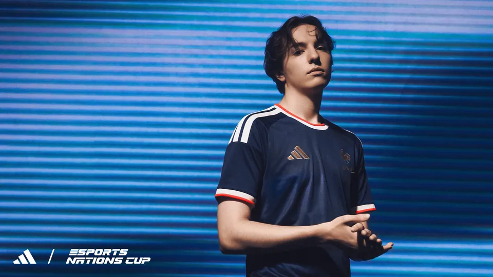 Someone wearing France's navy adidas Esports Nations Cup jersey in front of a blue backdrop