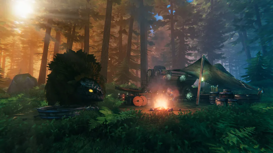A large shaggy creature with a glowing yellow eye resting beside a campfire, a cart of barrels and a green tent in a sunlit pine forest