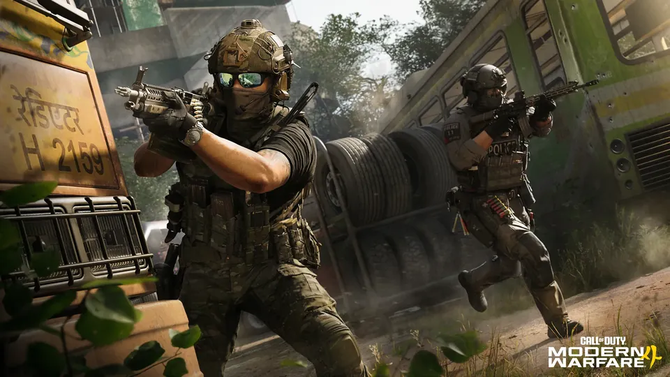 Operators in tactical gear advance with rifles past a bus and a stack of tires in Modern Warfare 4