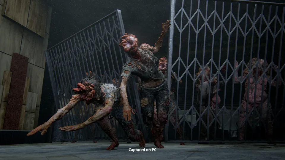 Infected crawling through a metal gate in The Last of Us Part II Remastered on PC