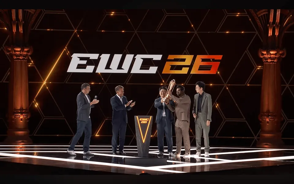 The Club Championship trophy is lifted on the EWC 26 stage in Paris as people in suits applaud
