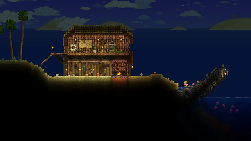 A lit wooden house with a dock stands on a dark shore by the ocean at dusk in Terraria