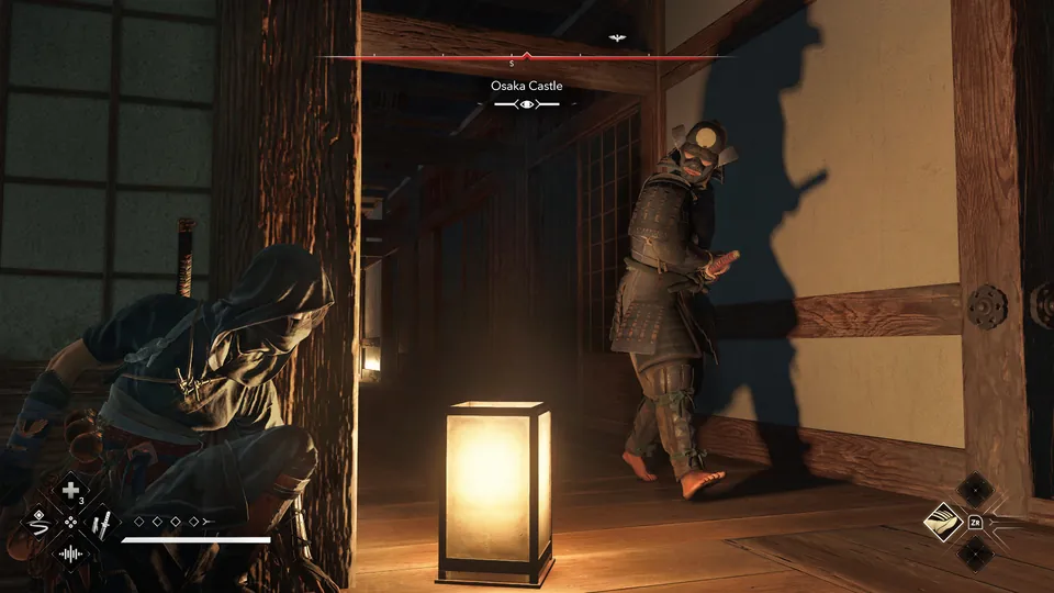 Naoe hides in a dark corridor of Osaka Castle while a guard walks past a lantern