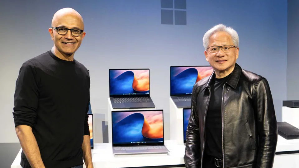 Microsoft CEO Satya Nadella and Nvidia CEO Jensen Huang in front of a table of RTX Spark laptops at the Oct. 7 event in San Francisco
