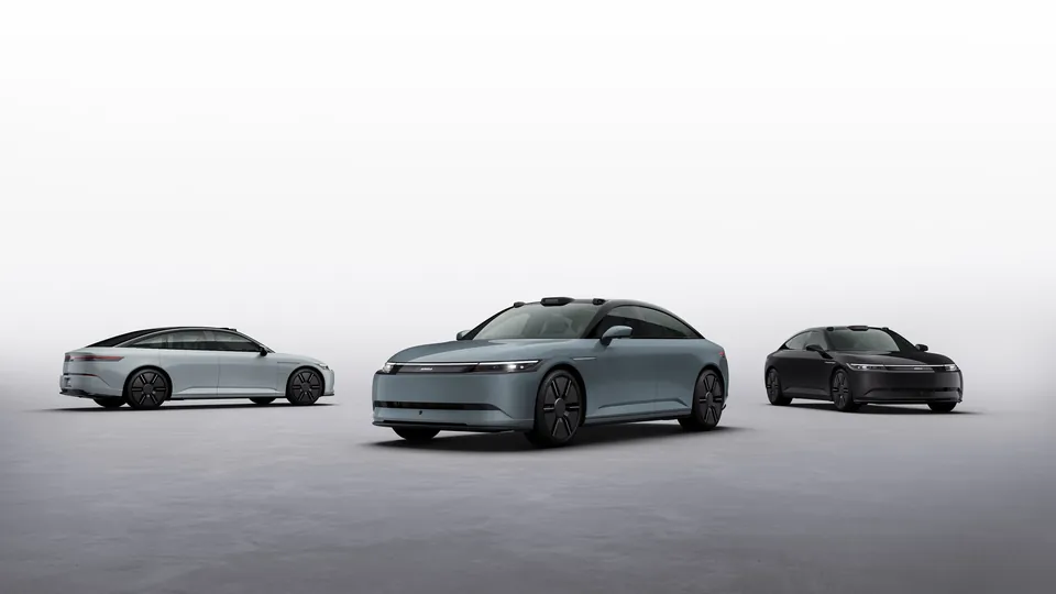 Three Afeela 1 sedans in white, gray and black on a gray studio floor
