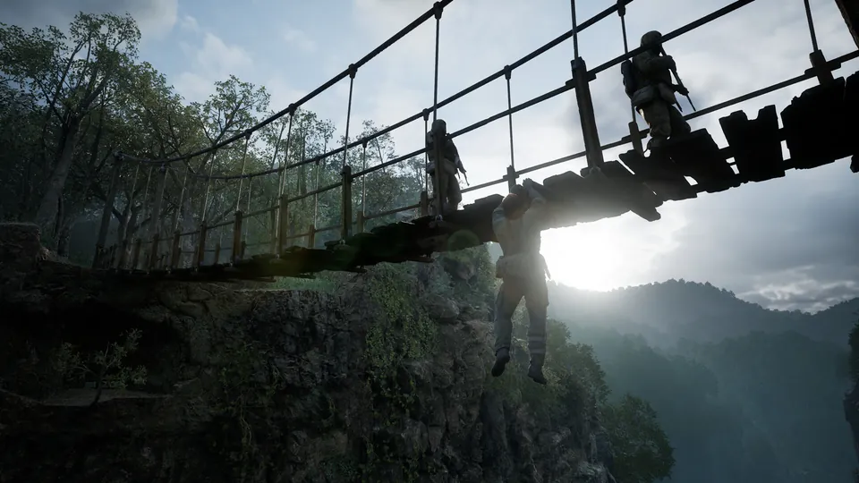 A soldier hangs below a rope bridge over a misty jungle gorge as guards walk across in Metal Gear Solid Delta: Snake Eater