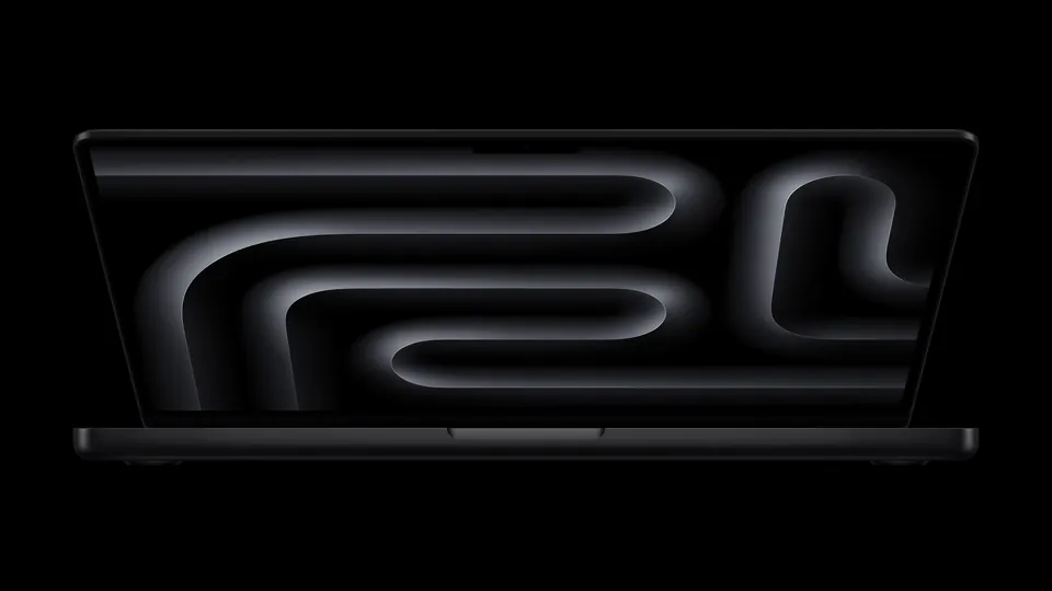 The MacBook Pro with M5 open, with a dark swirl wallpaper on its screen