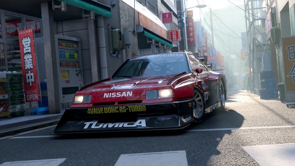 A red Nissan Skyline race car on a sunny Japanese city street